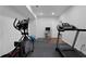 Finished basement gym with treadmill, elliptical machine and cushioned flooring at 3980 Suwanee Place Dr, Suwanee, GA 30024