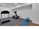 Finished basement gym with treadmill, elliptical machine, exercise ball and cushioned flooring at 3980 Suwanee Place Dr, Suwanee, GA 30024