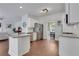 Open-concept kitchen with white cabinets, granite countertops, and a central island at 3980 Suwanee Place Dr, Suwanee, GA 30024