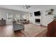 Cozy living room with hardwood floors, fireplace and a large window at 3980 Suwanee Place Dr, Suwanee, GA 30024