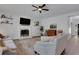 Spacious living room featuring hardwood floors, fireplace and open access to entry at 3980 Suwanee Place Dr, Suwanee, GA 30024