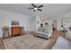 Open concept living room with hardwood floors and views into the kitchen and dining areas at 3980 Suwanee Place Dr, Suwanee, GA 30024