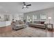 Spacious living room featuring hardwood floors, lots of natural light, and access to the dining area at 3980 Suwanee Place Dr, Suwanee, GA 30024