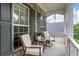 Relaxing front porch featuring comfortable seating and views of the surrounding neighborhood at 3980 Suwanee Place Dr, Suwanee, GA 30024