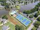 Aerial view showcasing the community pool, tennis courts, and lake, highlighting the amenities at 4000 Longlake Dr, Duluth, GA 30097