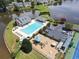 Aerial view showcasing the community pool, playground, and lake, surrounded by green spaces and parking at 4000 Longlake Dr, Duluth, GA 30097