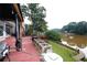 Backyard with a large wooden deck, and a waterfront view at 4000 Longlake Dr, Duluth, GA 30097