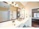 Bright and airy bathroom features dual sinks, large mirror, and access to bedroom at 4000 Longlake Dr, Duluth, GA 30097