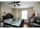 Bedroom featuring a ceiling fan, hardwood floors, a queen sized bed and natural light from the window at 4000 Longlake Dr, Duluth, GA 30097