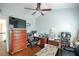 Bedroom with a ceiling fan, hardwood floors, a flat screen television and a work area at 4000 Longlake Dr, Duluth, GA 30097