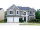 Charming two-story home with a two-car garage and manicured landscaping at 4000 Longlake Dr, Duluth, GA 30097