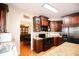 Open kitchen layout with dark cabinetry and granite countertops, next to the dining area at 4000 Longlake Dr, Duluth, GA 30097