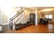 Open-concept space with hardwood floors and staircase offers seamless flow to dining area at 4000 Longlake Dr, Duluth, GA 30097