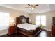 Tranquil main bedroom features tray ceilings, ample natural light, and a king-size bed at 4000 Longlake Dr, Duluth, GA 30097