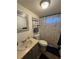 Bathroom featuring a vanity with sink, toilet, and shower with decorative shower curtain at 4282 By Pass, Loganville, GA 30052