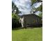 Exterior side view of home with yard, trees, and a stair case leading to the back at 4282 By Pass, Loganville, GA 30052