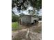 Cozy home exterior showing the side, yard, and an outside window with trees in the background at 4282 By Pass, Loganville, GA 30052