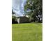 A charming single-story home with a lush green lawn and additional storage structure at 4282 By Pass, Loganville, GA 30052