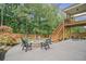 Spacious backyard with a stone fire pit, patio, upper deck, and mature trees at 4960 Norman Ct, Cumming, GA 30040