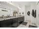 This is a large main bathroom with dual sinks, dark cabinets and black hardware at 4960 Norman Ct, Cumming, GA 30040