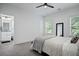 This is a bright bedroom with neutral colors, plush carpeting and ensuite bath at 4960 Norman Ct, Cumming, GA 30040