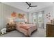 This charming bedroom boasts a playful wallpaper and soft decor at 4960 Norman Ct, Cumming, GA 30040