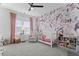 This adorable bedroom has a floral wall, bright accents and plenty of space at 4960 Norman Ct, Cumming, GA 30040