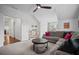 Spacious bonus room features plush carpet, ceiling fan, and a comfortable sectional sofa with colorful pillows at 4960 Norman Ct, Cumming, GA 30040