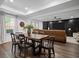Bright dining area with hardwood floors, modern lighting, and a rustic wood table set for six at 4960 Norman Ct, Cumming, GA 30040