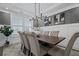 Elegant dining room with modern light fixture, textured wallpaper, and seating for six at 4960 Norman Ct, Cumming, GA 30040