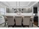 Staged dining room featuring a dark wooden table and decoratively upholstered chairs at 4960 Norman Ct, Cumming, GA 30040