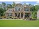 Charming two-story home with a manicured lawn, stone accents, and a welcoming front porch at 4960 Norman Ct, Cumming, GA 30040