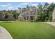 Beautiful home with a spacious lawn, mature trees, and a basketball hoop on the driveway at 4960 Norman Ct, Cumming, GA 30040