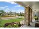 Covered porch featuring stone pillars, lush landscaping, and a welcoming view at 4960 Norman Ct, Cumming, GA 30040