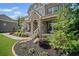 Charming front porch with stone columns and landscaped garden beds at 4960 Norman Ct, Cumming, GA 30040