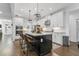 Bright and airy kitchen featuring a black island, hardwood floors, and modern light fixtures at 4960 Norman Ct, Cumming, GA 30040