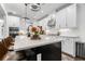 Kitchen featuring a large island with barstools and modern light fixtures at 4960 Norman Ct, Cumming, GA 30040