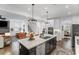 Open-concept kitchen with a large island, stainless steel appliances, and hardwood floors at 4960 Norman Ct, Cumming, GA 30040