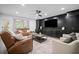 Inviting living room features a built-in entertainment center, leather sofas, and plush seating at 4960 Norman Ct, Cumming, GA 30040