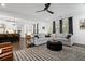 Open living space featuring hardwood floors, a spacious sectional, and a view of the kitchen at 4960 Norman Ct, Cumming, GA 30040