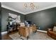 Stylish home office featuring a large desk, elegant decor, and ample natural light at 4960 Norman Ct, Cumming, GA 30040