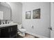 Chic powder room with a modern vanity, decorative mirror, and stylish wallpaper at 4960 Norman Ct, Cumming, GA 30040