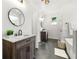 Modern bathroom boasts dual vanities, sleek fixtures, and a freestanding tub for relaxation at 8544 Plumtree Dr, Riverdale, GA 30274
