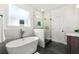 Luxurious bathroom featuring a soaking tub, walk-in shower, and modern fixtures at 8544 Plumtree Dr, Riverdale, GA 30274