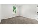 Bright bedroom with neutral carpet and a window offering natural light at 8544 Plumtree Dr, Riverdale, GA 30274