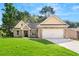 Charming brick home with a well-manicured lawn, attached garage, and welcoming entryway at 8544 Plumtree Dr, Riverdale, GA 30274