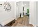 Stylish hallway featuring wood floors and leading into a comfortable and inviting living room at 8544 Plumtree Dr, Riverdale, GA 30274