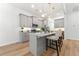 Modern kitchen featuring an island with bar seating, gray cabinets, and granite countertops at 8544 Plumtree Dr, Riverdale, GA 30274