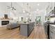 Open-concept living space with kitchen island, stainless appliances, and comfortable seating area at 8544 Plumtree Dr, Riverdale, GA 30274