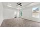Spacious main bedroom with tray ceiling, ceiling fan, and natural light at 8544 Plumtree Dr, Riverdale, GA 30274
